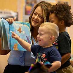 teacher reading to two children