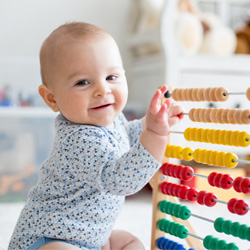 baby playing with counting toy