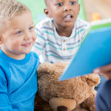 two boys reading a book